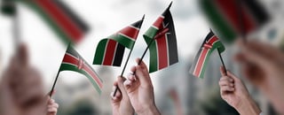 A group of individuals brandishing tiny Kenyan flags A group of individuals brandishing tiny Kenyan flags