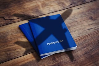 Blue passport with the airplane shadow