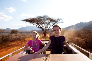 Going on Safari Two Girls Standing on Top of Jeep Going on Safari Two Girls Standing on Top of Jeep