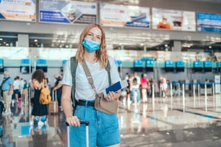 Happy Young Tourist Woman in a Protectiv Medical Mask Holding Passport Waiting for Checking Happy Young Tourist Woman in a Protectiv Medical Mask Holding Passport Waiting for Checking