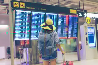 Young Woman Traveler In International Airport Looking At The Flight Information